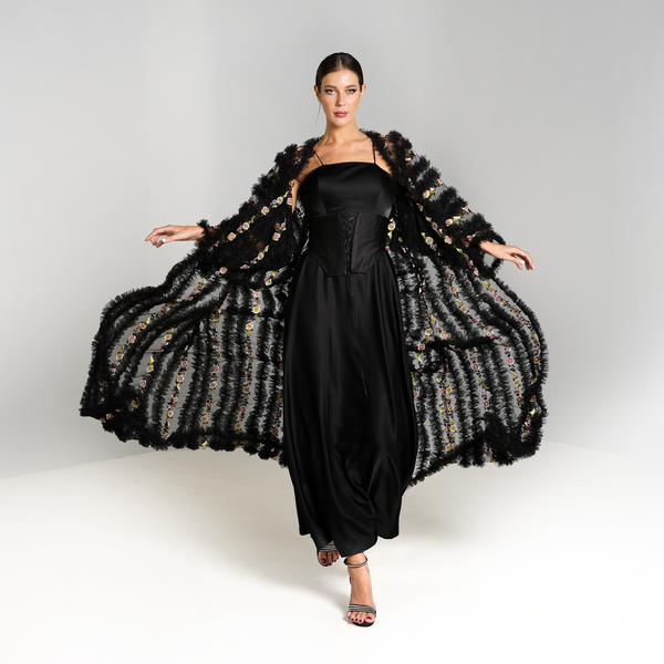 Black abaya with floral designs, worn over a black corset dress